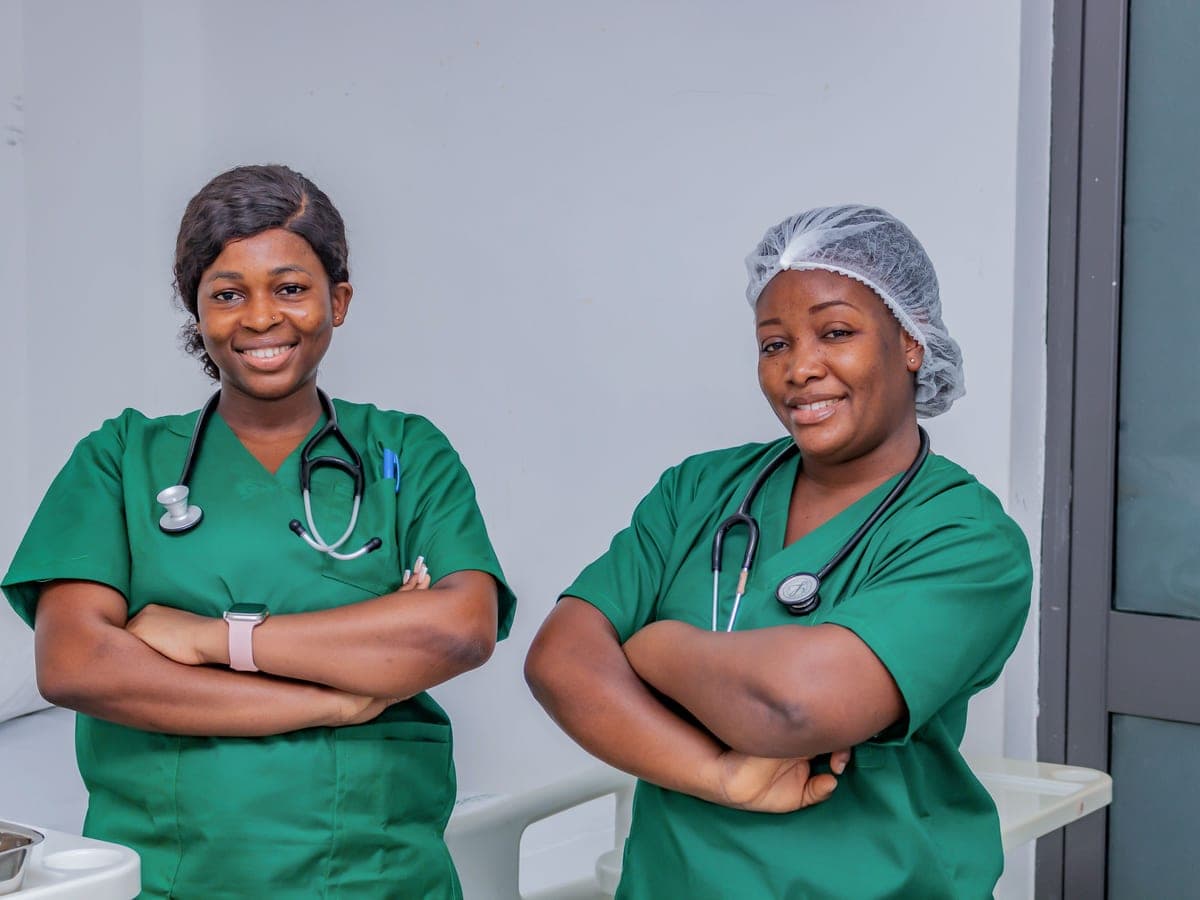 Two nurses in scrubs on a hospital ward