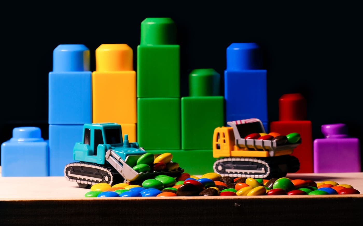 Brightly coloured moulded plastic parts on a bench