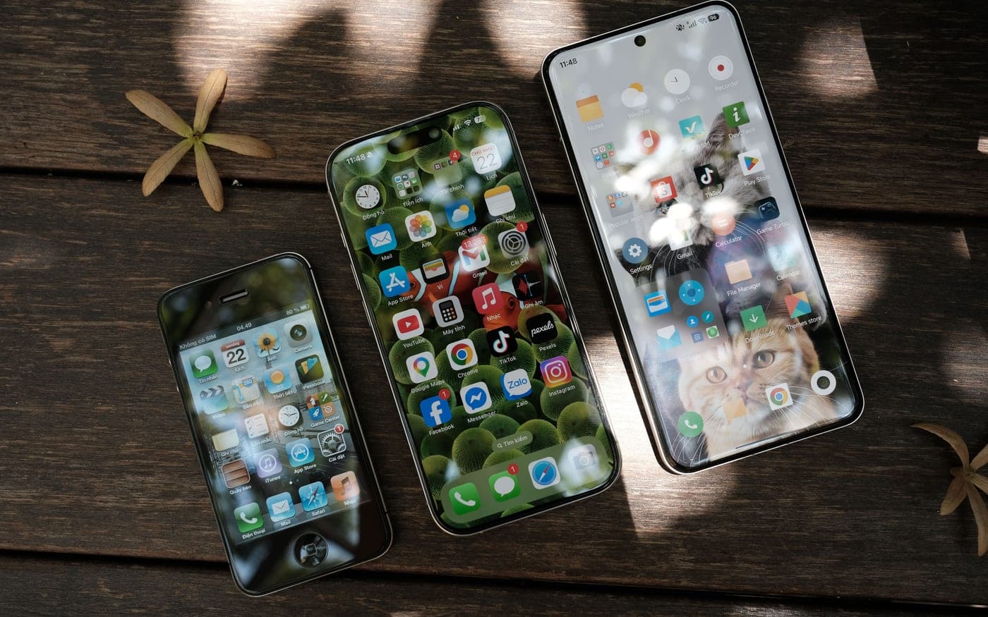 Three handsets face-up, each showing its home screen