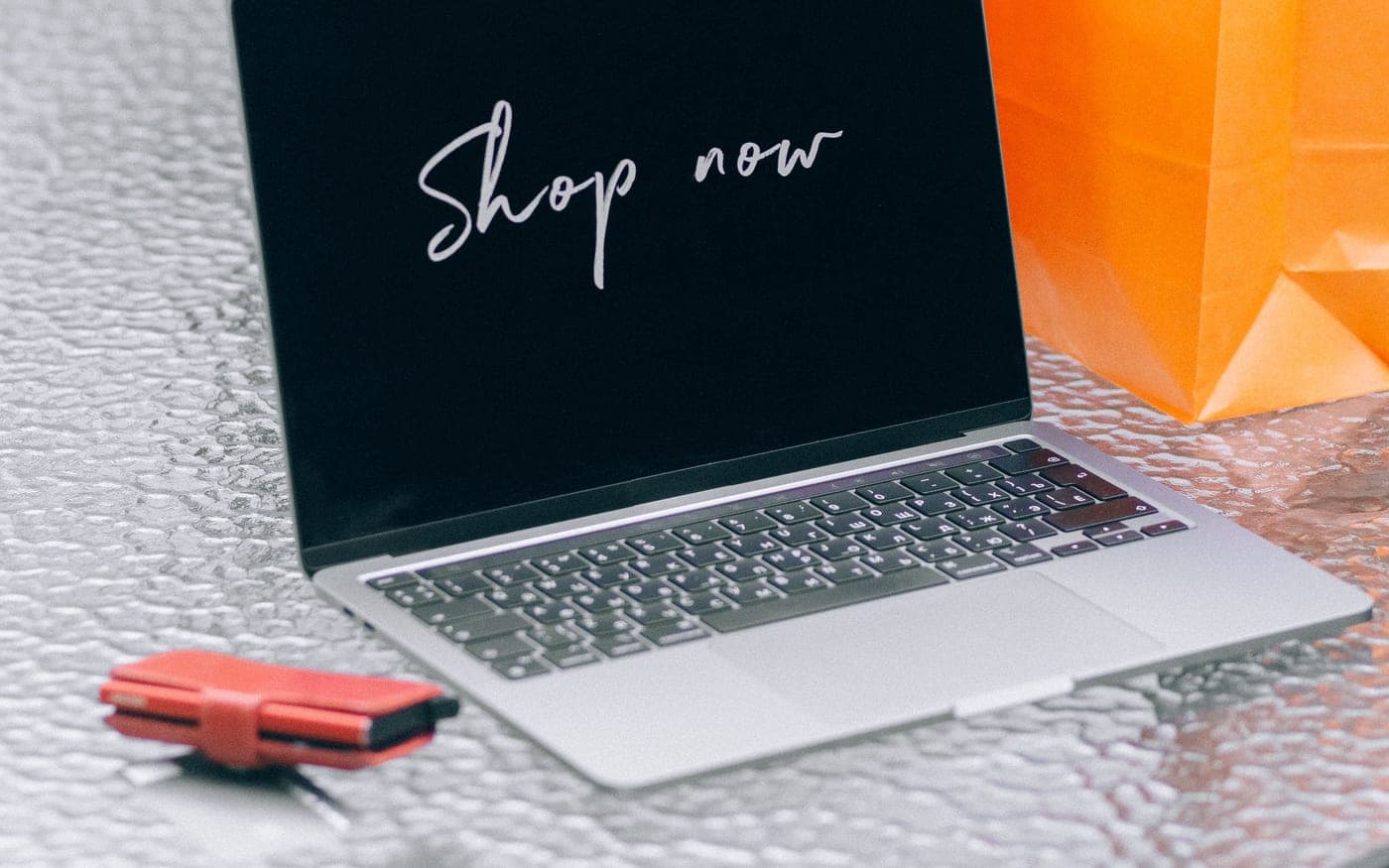 A laptop open on an online shop, with the bags that came of it